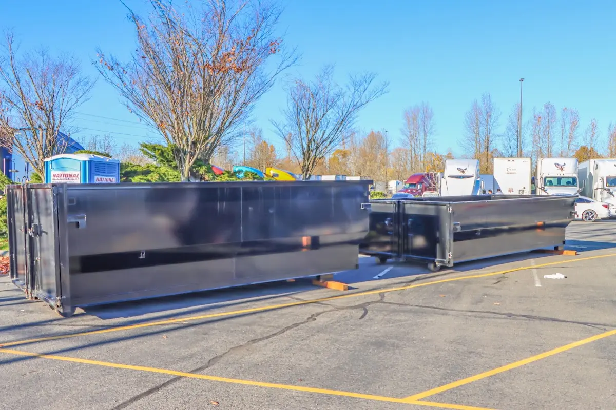 Professional dumpster rental service with roll-off container on residential driveway in Avon